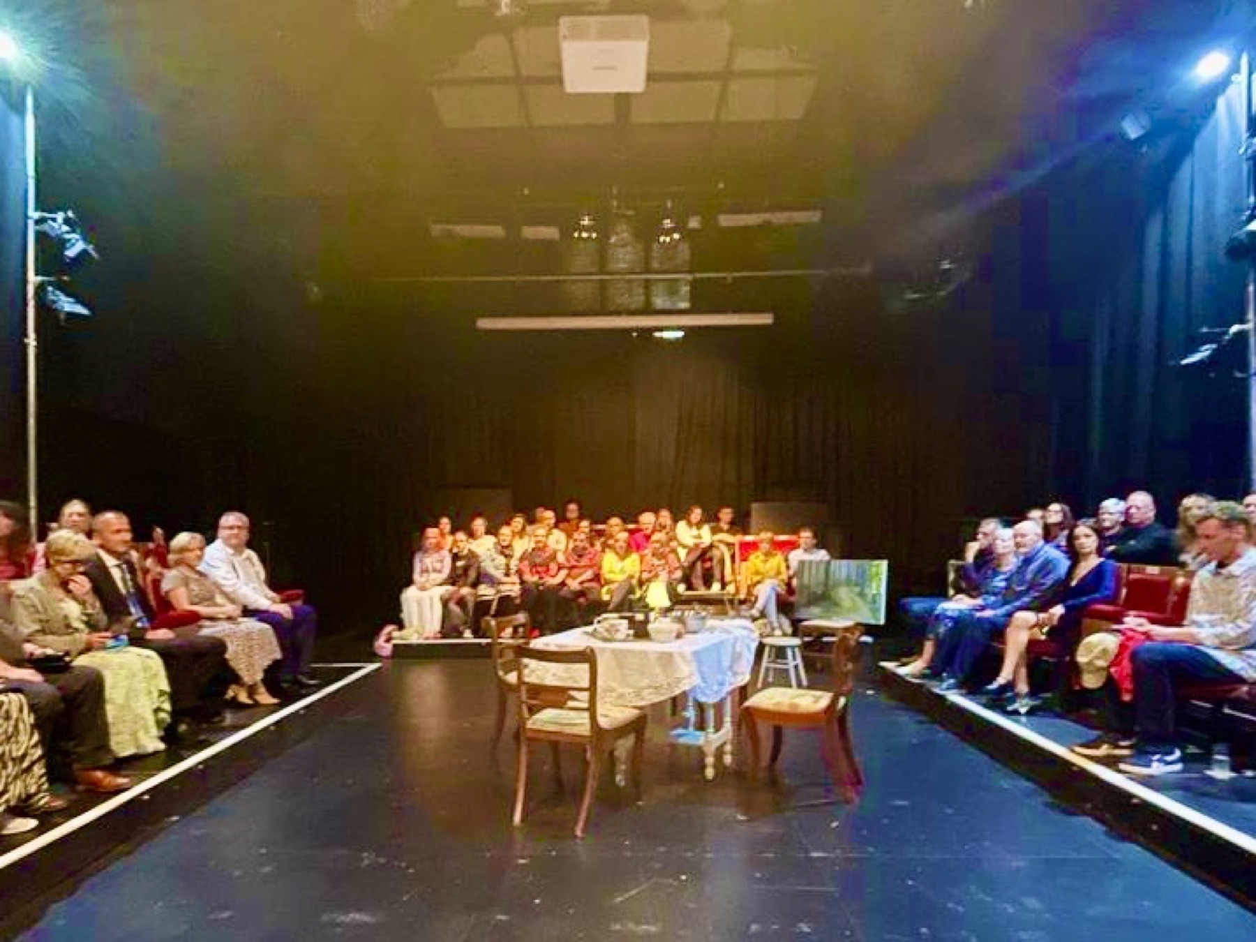 The audience surrounding the playing space