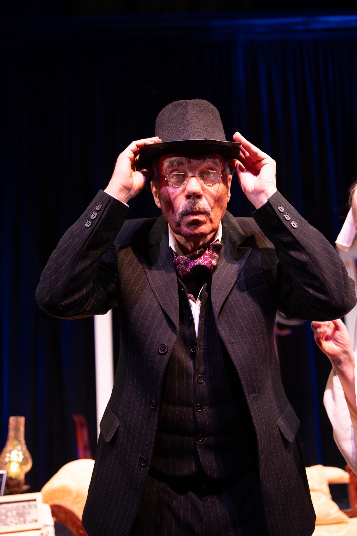 A performer tipping his hat