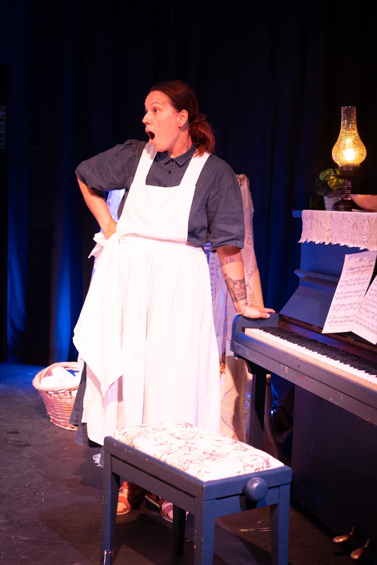 A performer beside the piano