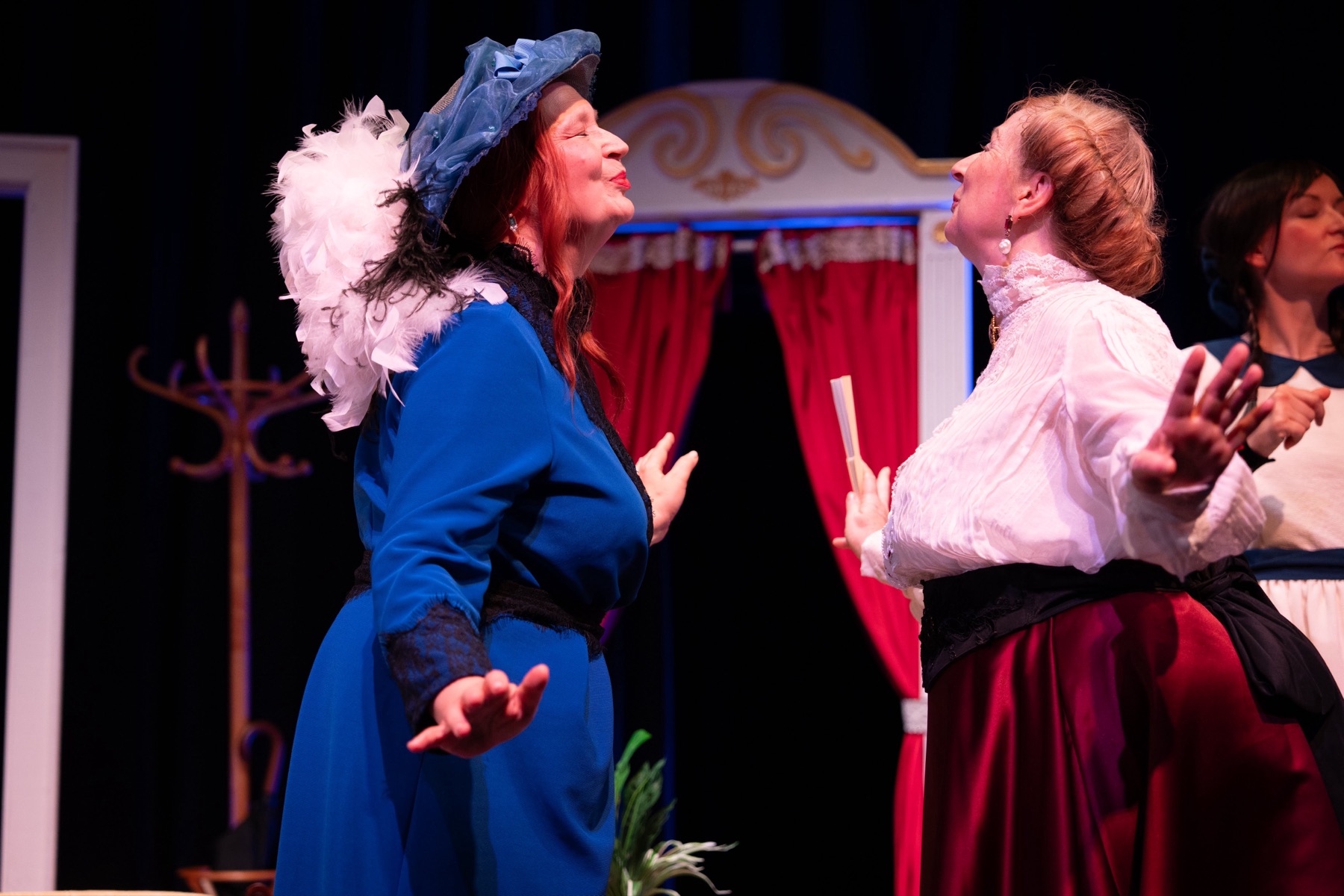 Three women in a charged stage encounter